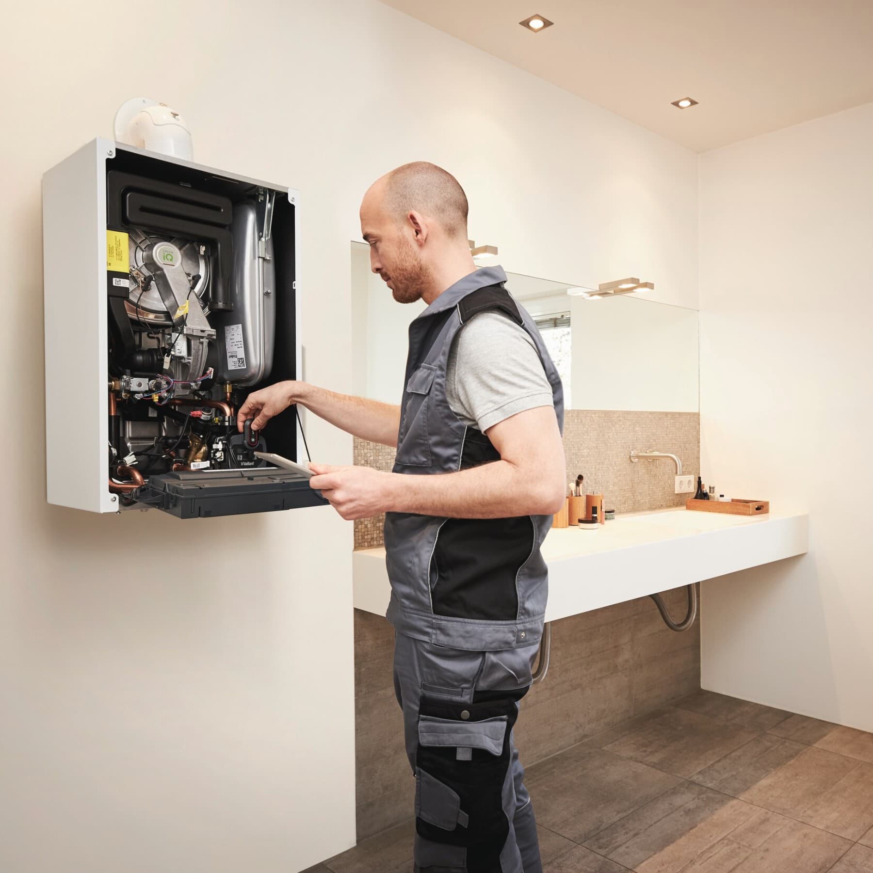 Servisný technik opravuje plynový kotol na stene v kúpeľni