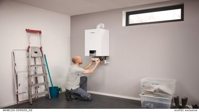 Servisný technik inštaluje internetový modul pod kotol